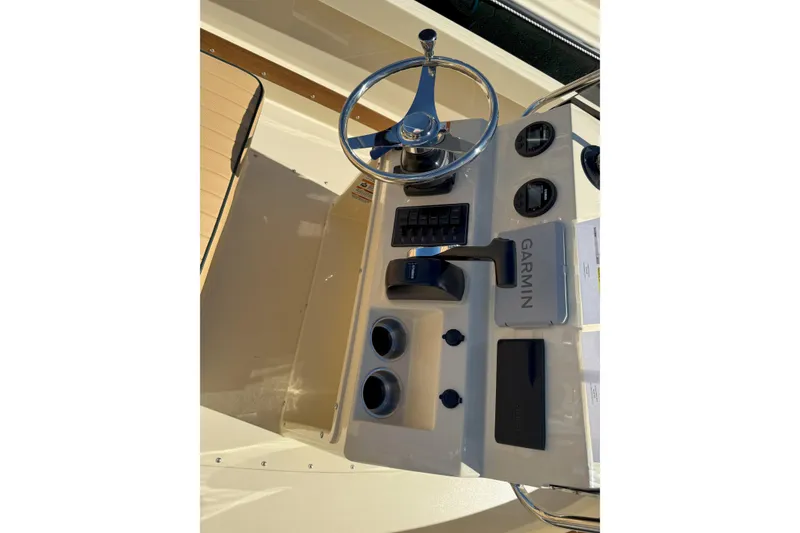 Slide: The Image of 2026 Rossiter 17 CC boat console with Garmin navigation system and steering wheel. - 7