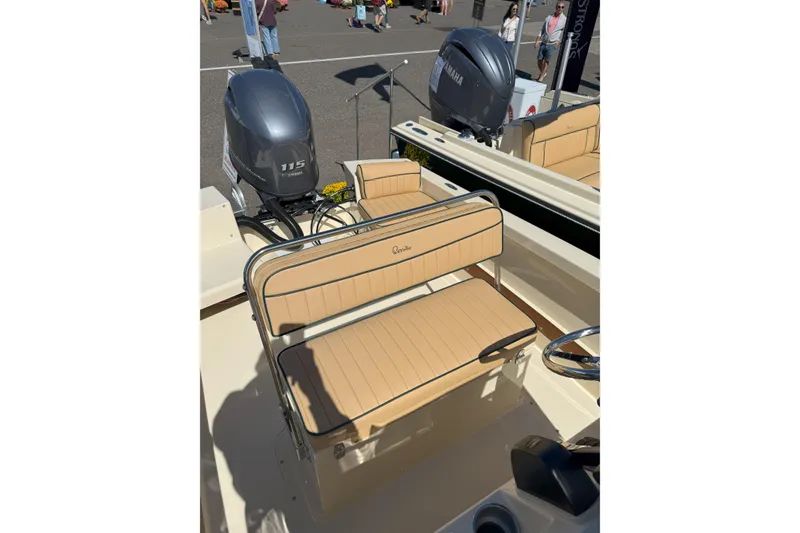 Slide: The Image of 2026 Rossiter 17 CC boat interior with tan seating and Yamaha outboard motor. - 9
