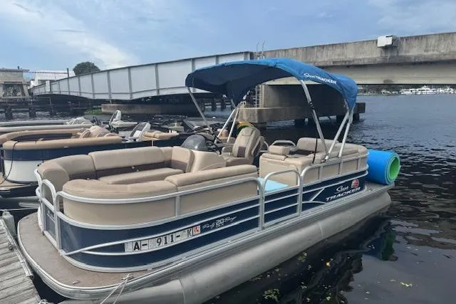 Slide: The Image of 2019 Sun Tracker Party Barge 20 DLX pontoon boat docked by a bridge. - 11