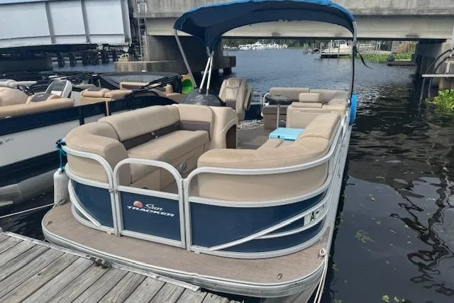 Slide: The Image of 2019 Sun Tracker Party Barge 20 DLX pontoon boat docked by a bridge. - 12