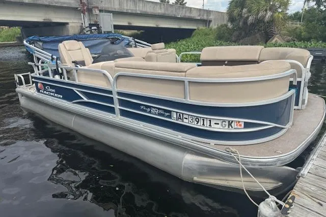 Slide: The Image of 2019 Sun Tracker Party Barge 20 DLX pontoon boat docked on a calm waterway. - 3