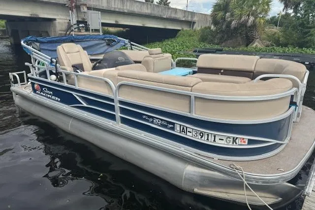 Slide: The Image of 2019 Sun Tracker Party Barge 20 DLX pontoon boat docked near a bridge. - 4