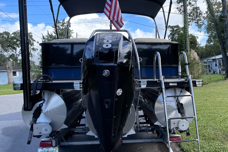Slide: The Image of 2022 Barletta Cabrio 22QC pontoon boat with powerful outboard motor and American flag. - 10