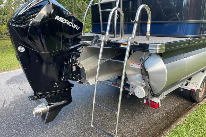 Slide: The Image of 2022 Barletta Cabrio 22QC pontoon boat with Mercury outboard motor and ladder. - 11