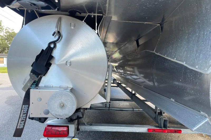 Slide: The Image of 2022 Barletta Cabrio 22QC pontoon boat underside with trailer and securing strap. - 15