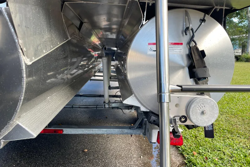 Slide: The Image of Underneath view of a 2022 Barletta Cabrio 22QC pontoon boat on a trailer. - 16