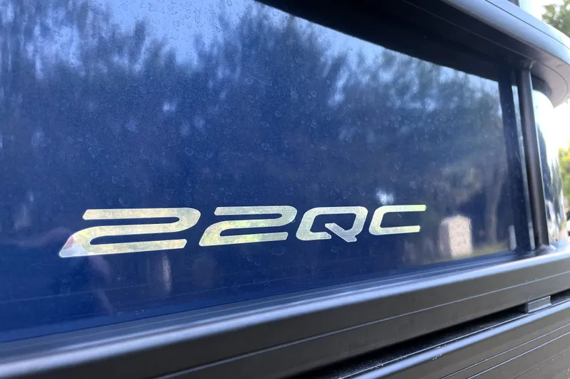 Slide: The Image of Close-up of 2022 Barletta Cabrio 22QC model emblem on a blue surface. - 19