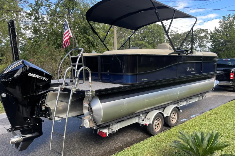 Slide: The Image of 2022 Barletta Cabrio 22QC pontoon boat on trailer with Mercury outboard motor. - 2