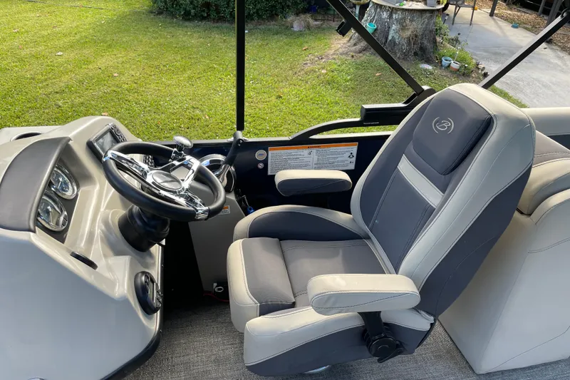 Slide: The Image of 2022 Barletta Cabrio 22QC boat interior with steering wheel and captain's chair. - 26