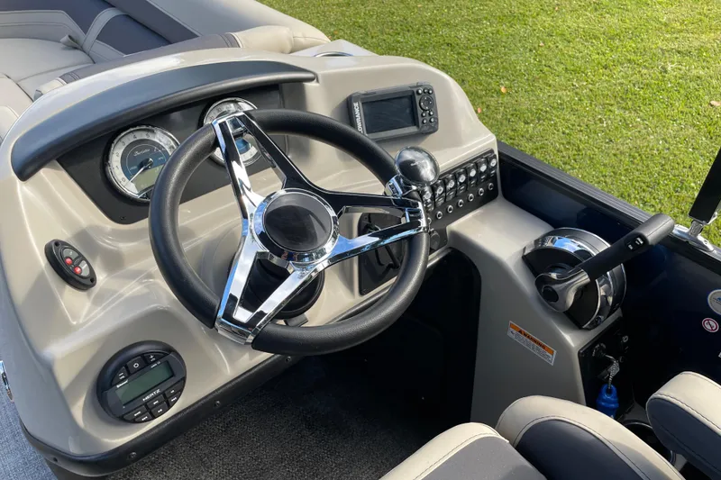 Slide: The Image of Steering console of 2022 Barletta Cabrio 22QC boat with modern controls and gauges. - 27