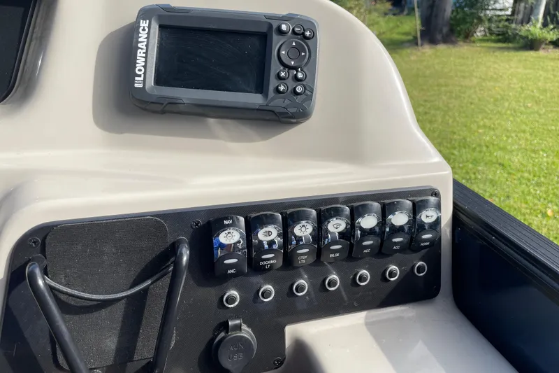 Slide: The Image of Control panel of 2022 Barletta Cabrio 22QC with Lowrance device and switches. - 29
