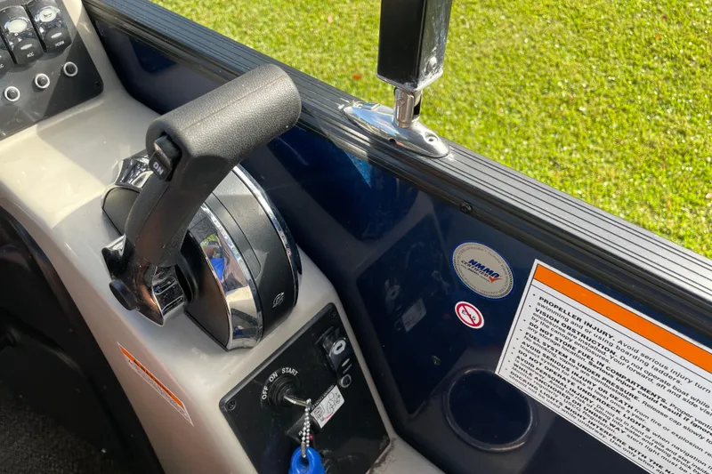 Slide: The Image of Control panel of 2022 Barletta Cabrio 22QC boat with throttle and safety instructions. - 31