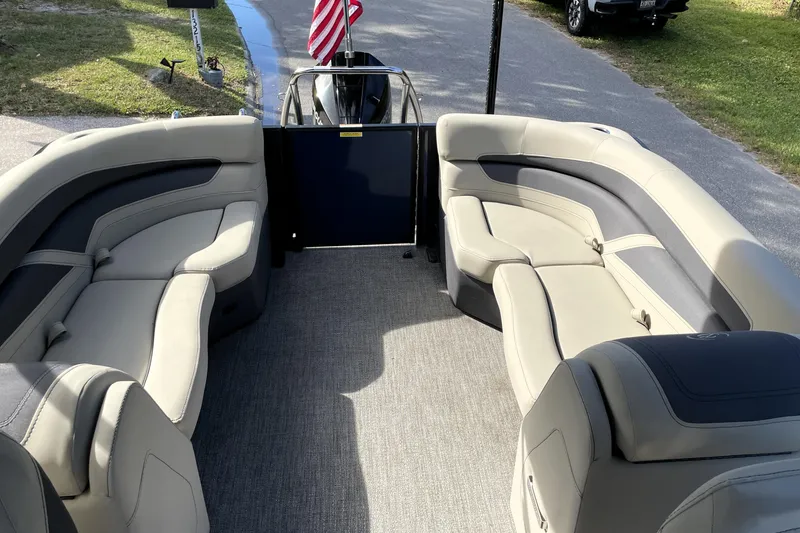 Slide: The Image of 2022 Barletta Cabrio 22QC pontoon boat interior with plush seating and American flag. - 34