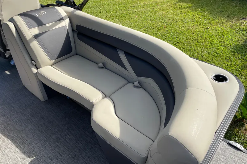 Slide: The Image of 2022 Barletta Cabrio 22QC boat interior seating with cup holder, gray and black upholstery. - 35