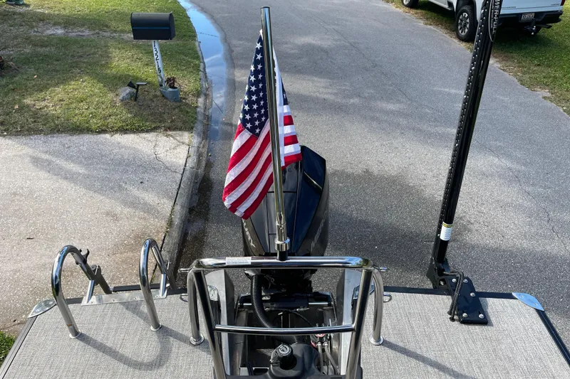 Slide: The Image of 2022 Barletta Cabrio 22QC boat with American flag on a residential street. - 37