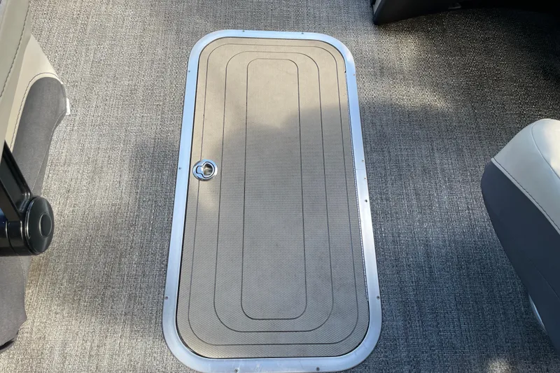 Slide: The Image of 2022 Barletta Cabrio 22QC boat floor with storage compartment and carpeted surface. - 39