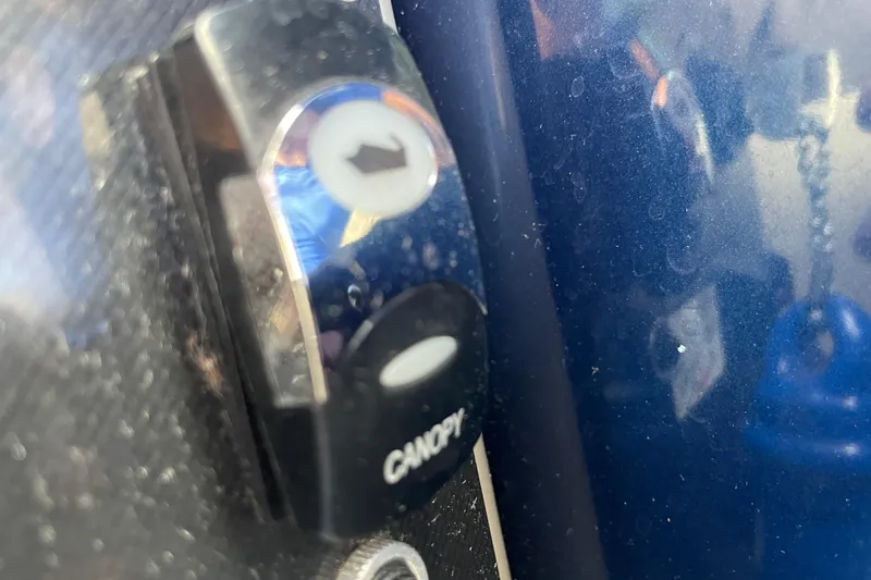 Slide: The Image of Close-up of a canopy button on a 2022 Barletta Cabrio 22QC boat. - 47