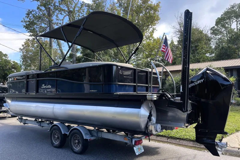 Slide: The Image of 2022 Barletta Cabrio 22QC pontoon boat on trailer, with canopy and Mercury engine. - 5
