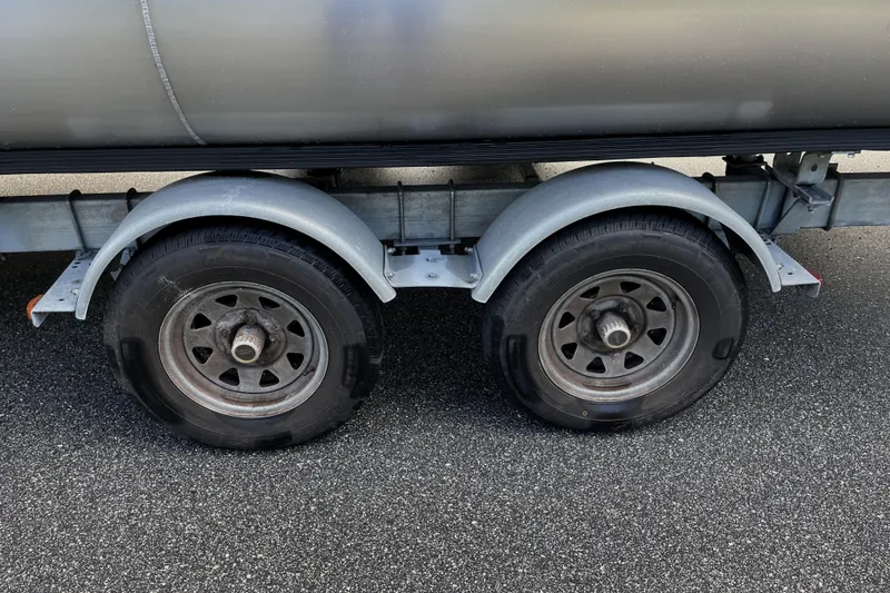 Slide: The Image of Trailer wheels of a 2022 Barletta Cabrio 22QC on asphalt road. - 50