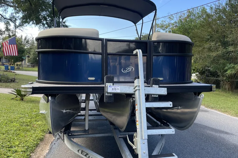 Slide: The Image of 2022 Barletta Cabrio 22QC pontoon boat on trailer, parked in residential area. - 6