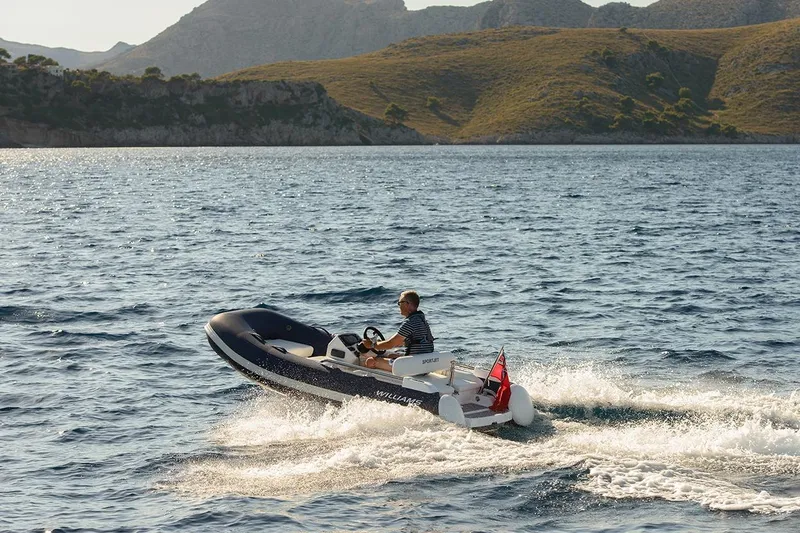 Slide: The Image of 2021 Williams Jet Tenders Sportjet 345 cruising on scenic coastal waters. - 13