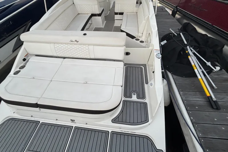 Slide: The Image of 2019 Sea Ray SDX 270 boat interior with white seating and gray decking. - 18