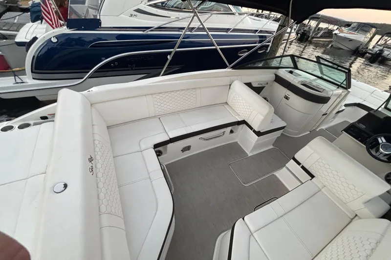 Slide: The Image of 2019 Sea Ray SDX 270 boat interior with white seating and modern design. - 20