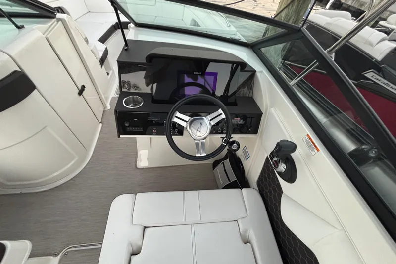 Slide: The Image of 2019 Sea Ray SDX 270 boat cockpit with steering wheel and control panel. - 23