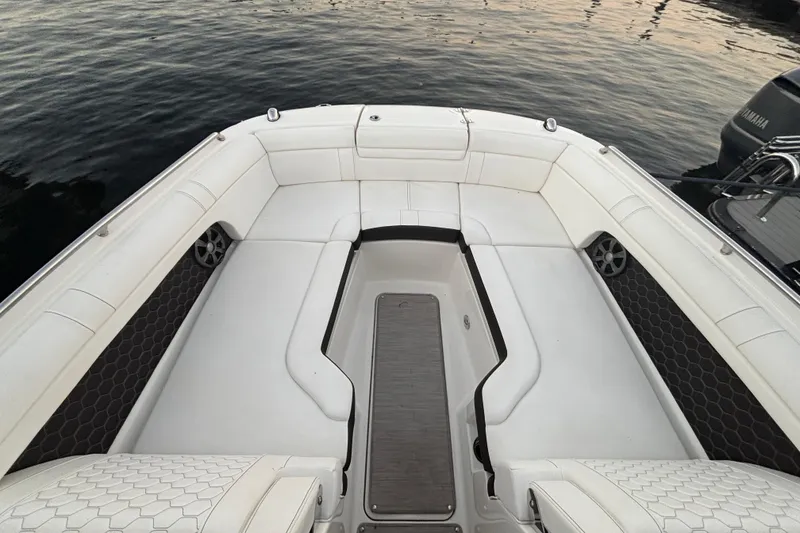 Slide: The Image of 2019 Sea Ray SDX 270 boat interior with white seating and water view. - 27