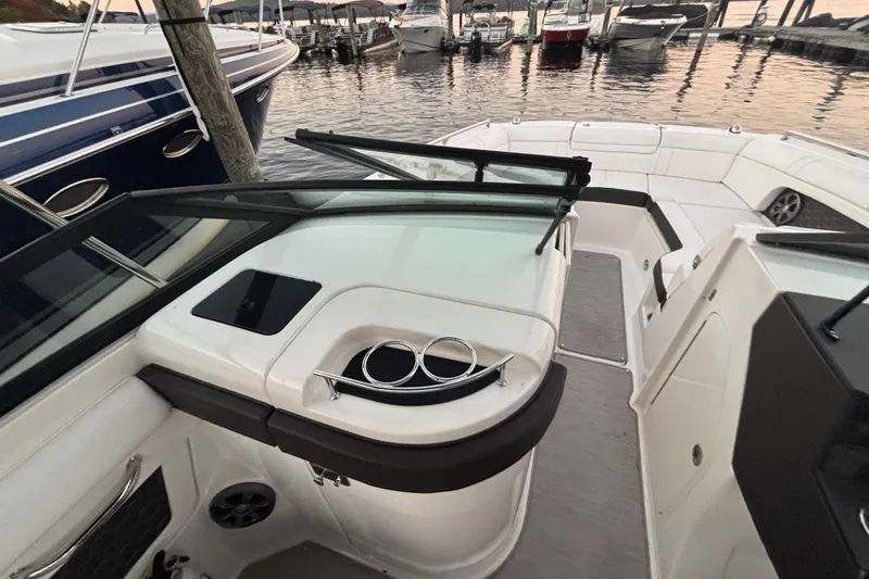 Slide: The Image of 2019 Sea Ray SDX 270 boat interior with cup holders, docked at marina. - 31