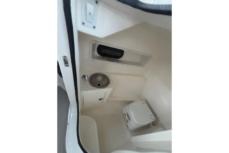 Slide: The Image of 2019 Sea Ray SDX 270 boat interior with sink and toilet. - 32