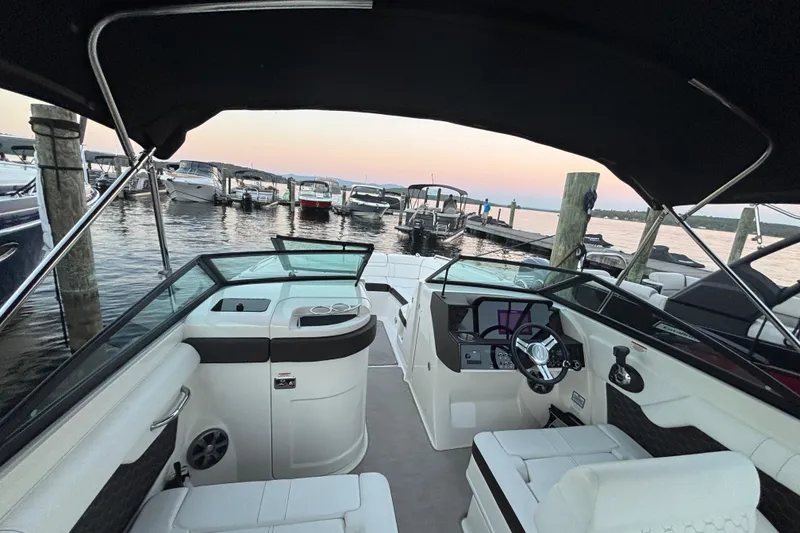 Slide: The Image of 2019 Sea Ray SDX 270 boat interior at marina during sunset. - 33