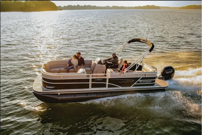 The Image of 2025 Ranger 220C pontoon boat cruising on a sunny lake with passengers enjoying the ride. - 1