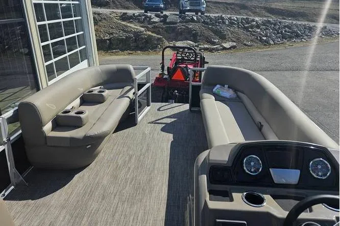 Slide: The Image of 2025 Ranger 220C pontoon boat interior with beige seating and dashboard. - 3