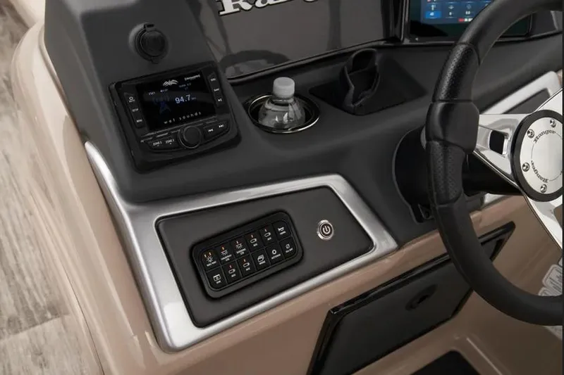 Slide: The Image of 2025 Ranger 220C boat dashboard with control panel, steering wheel, and radio system. - 8