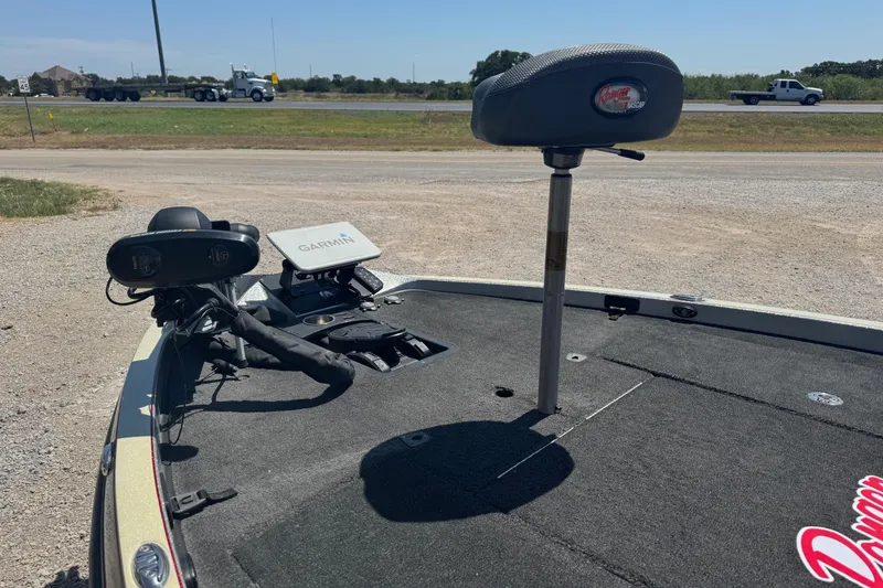 Slide: The Image of 2014 Ranger Z521 Comanche boat deck with Garmin equipment and seat, parked near a road. - 5