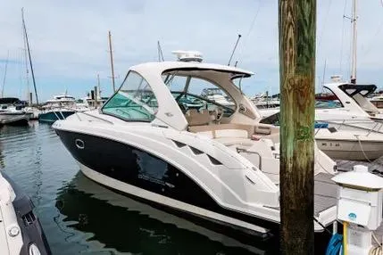 The Image of 2011 Chaparral 330 Signature boat docked in a marina, side view. - 0