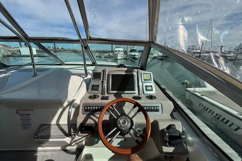 Slide: The Image of 2011 CHAPPARELL Signature 330 boat cockpit with steering wheel and navigation controls. - 11