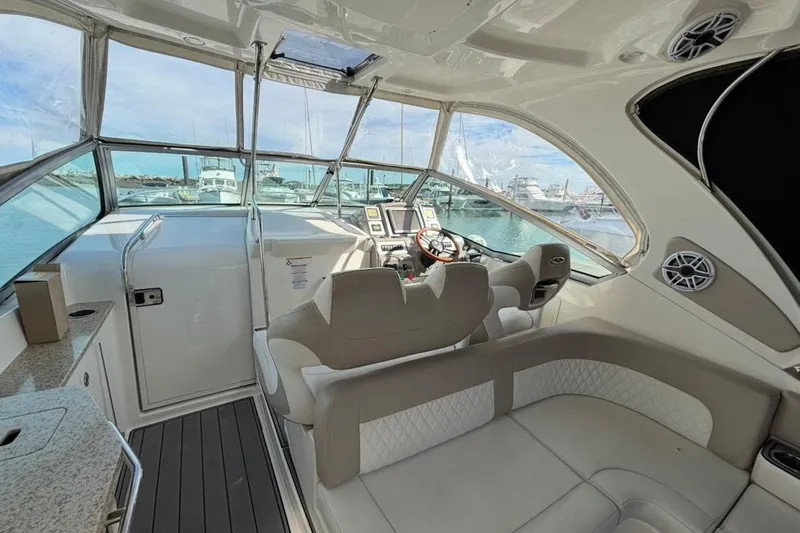 Slide: The Image of 2011 CHAPPARELL Signature 330 yacht interior with helm, seating, and marina view. - 12