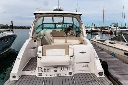 Slide: The Image of 2011 Chaparral 330 Signature boat docked, featuring spacious seating and sleek design. - 2