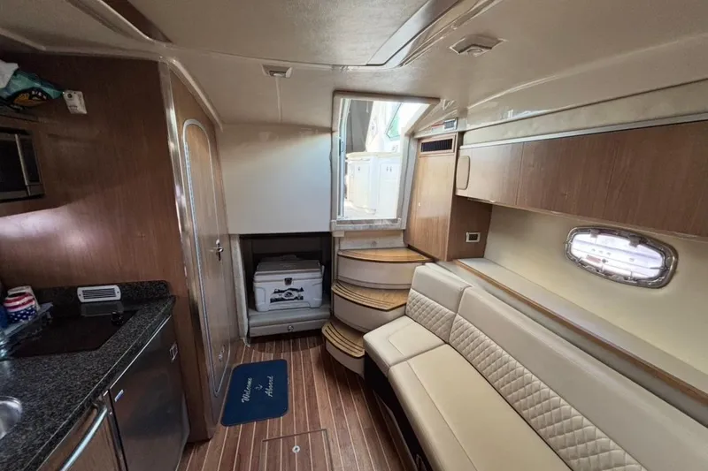 Slide: The Image of Interior of 2011 CHAPPARELL Signature 330 boat with modern kitchen and seating area. - 21