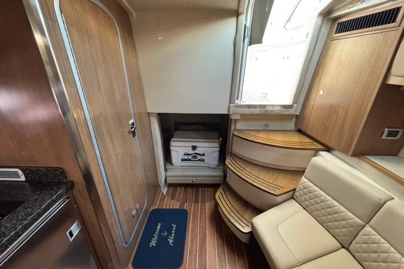 Slide: The Image of 2011 CHAPPARELL Signature 330 interior with wood finish, steps, and seating. - 25