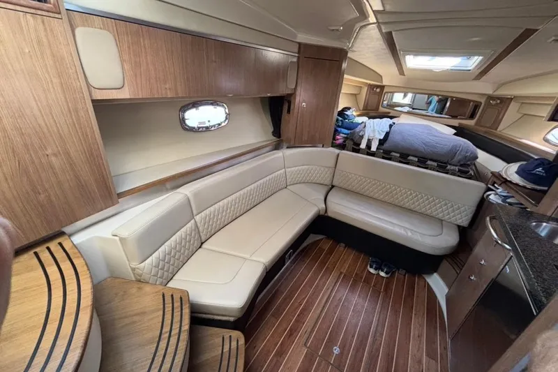 Slide: The Image of 2011 CHAPPARELL Signature 330 interior with beige seating and wooden accents. - 26