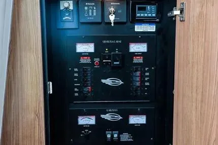 Slide: The Image of Electrical panel inside 2011 Chaparral 330 Signature boat, featuring various controls and gauges. - 29