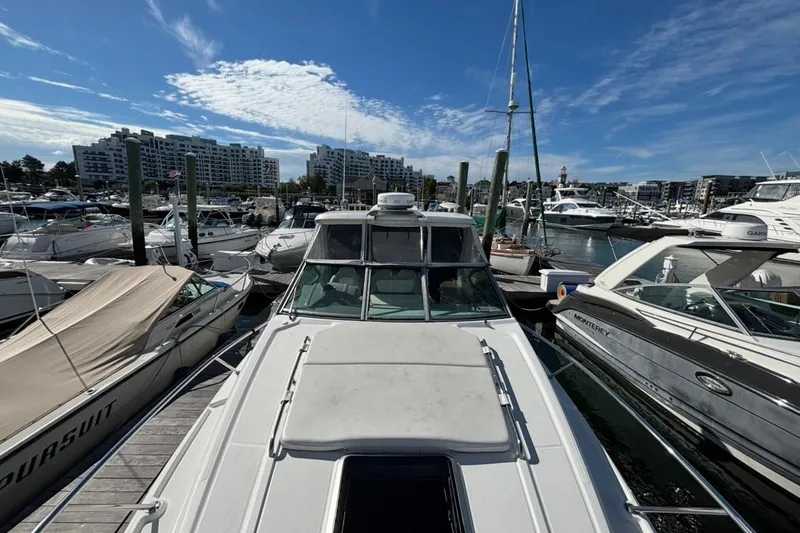Slide: The Image of 2011 CHAPPARELL Signature 330 docked at a marina, surrounded by other boats under a clear blue sky. - 4