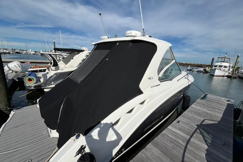 Slide: The Image of 2011 CHAPPARELL Signature 330 boat docked at marina under clear blue sky. - 7