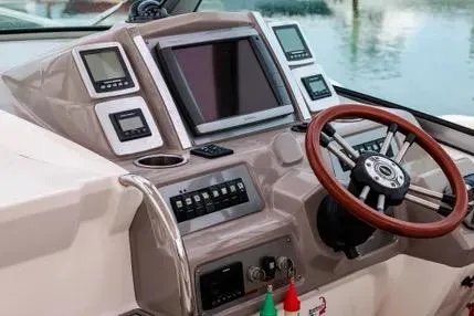 Slide: The Image of 2011 Chaparral 330 Signature boat dashboard with steering wheel and navigation controls. - 9