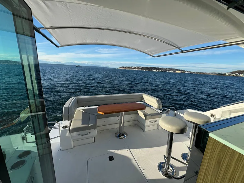 Slide: The Image of 2024 Cruisers Yachts 50 Cantius aft deck with seating and ocean view. - 10