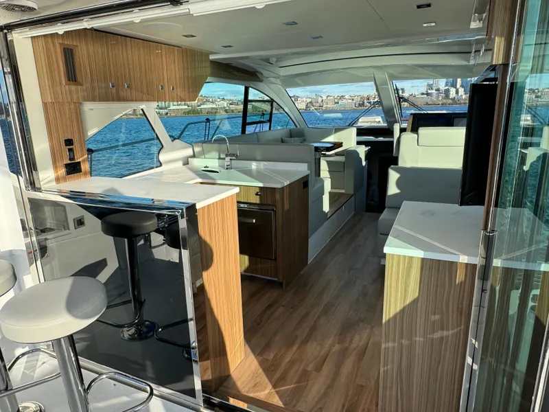 Slide: The Image of Interior of 2024 Cruisers Yachts 50 Cantius with modern kitchen and seating area. - 12