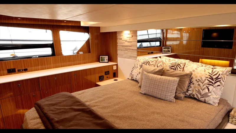 Slide: The Image of Luxurious bedroom interior of 2024 Cruisers Yachts 50 Cantius with modern decor and large windows. - 47